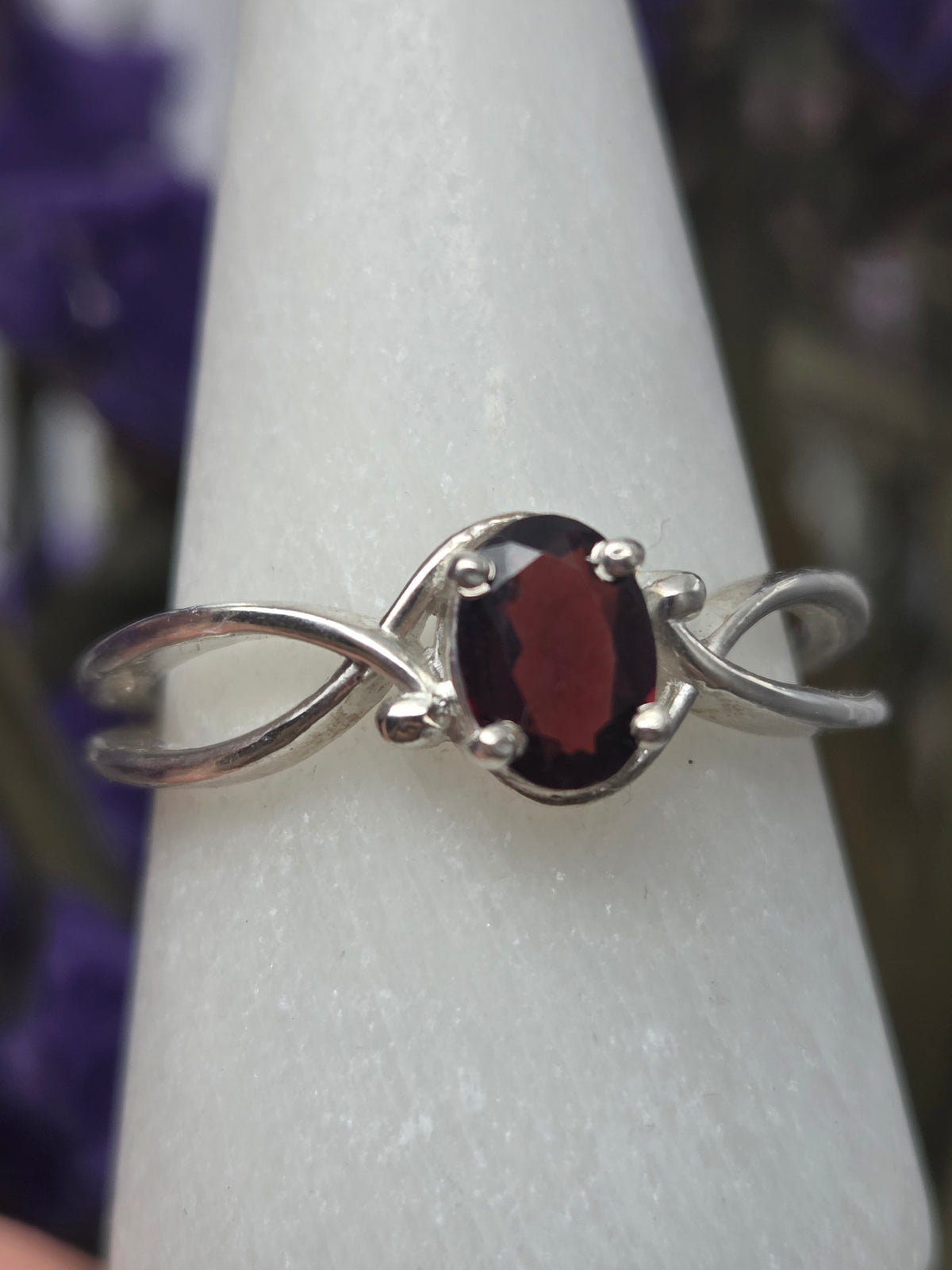 Garnet ring with deep red gemstone set in a polished band