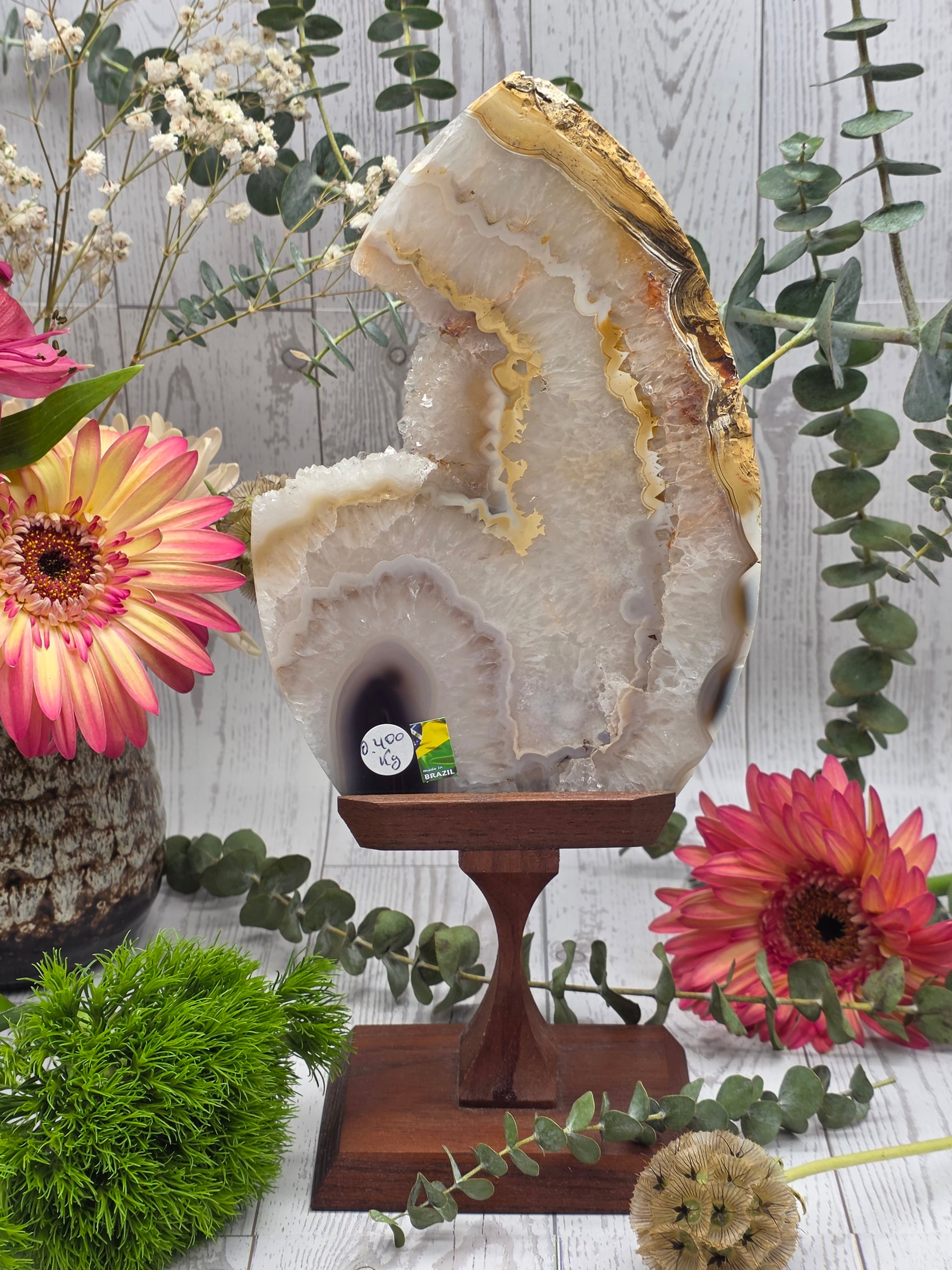 Agate slice with druzy on a wooden stand