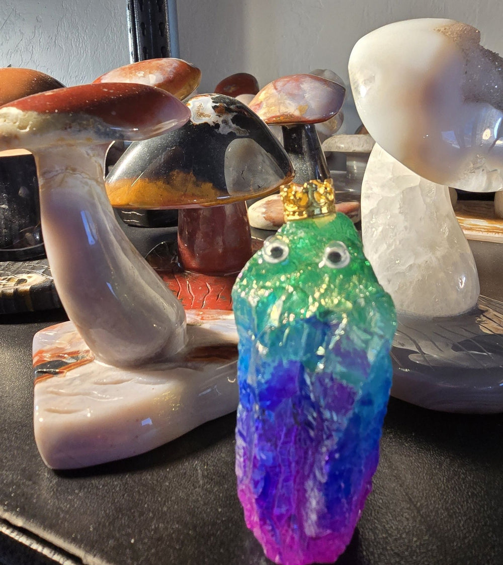 Colorful Aura crystal character among carved stone mushrooms