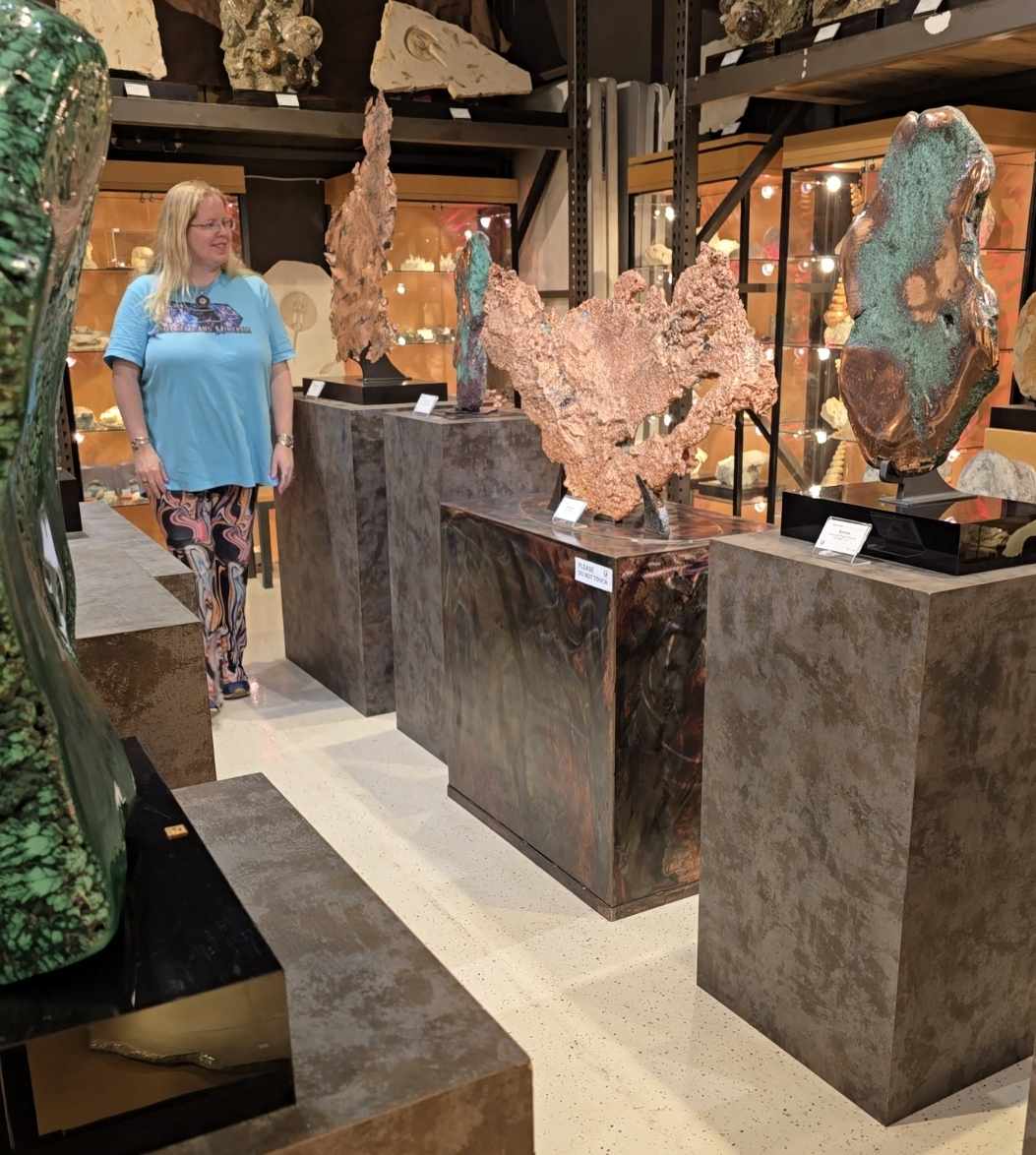 Stacy explores large mineral specimens at a gem show