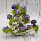Crystal skeleton figurine with purple crystals and green moss