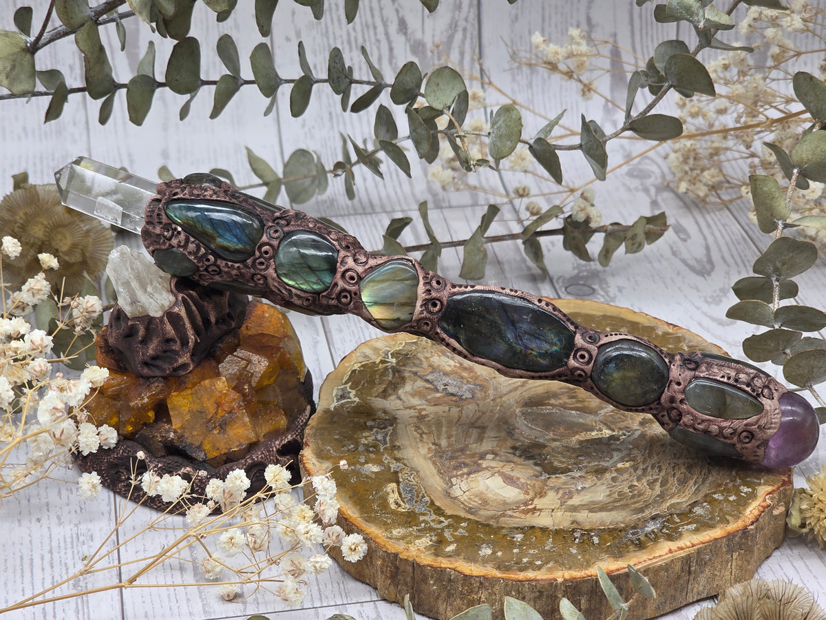 Handmade labradorite, amethyst, and clear quartz wand on display