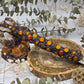 Handcrafted carnelian wand with agate and quartz on a wooden surface