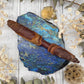 Gobi Desert Agate Wand on a blue stone background