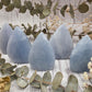 Polished blue calcite flames surrounded by dried flowers