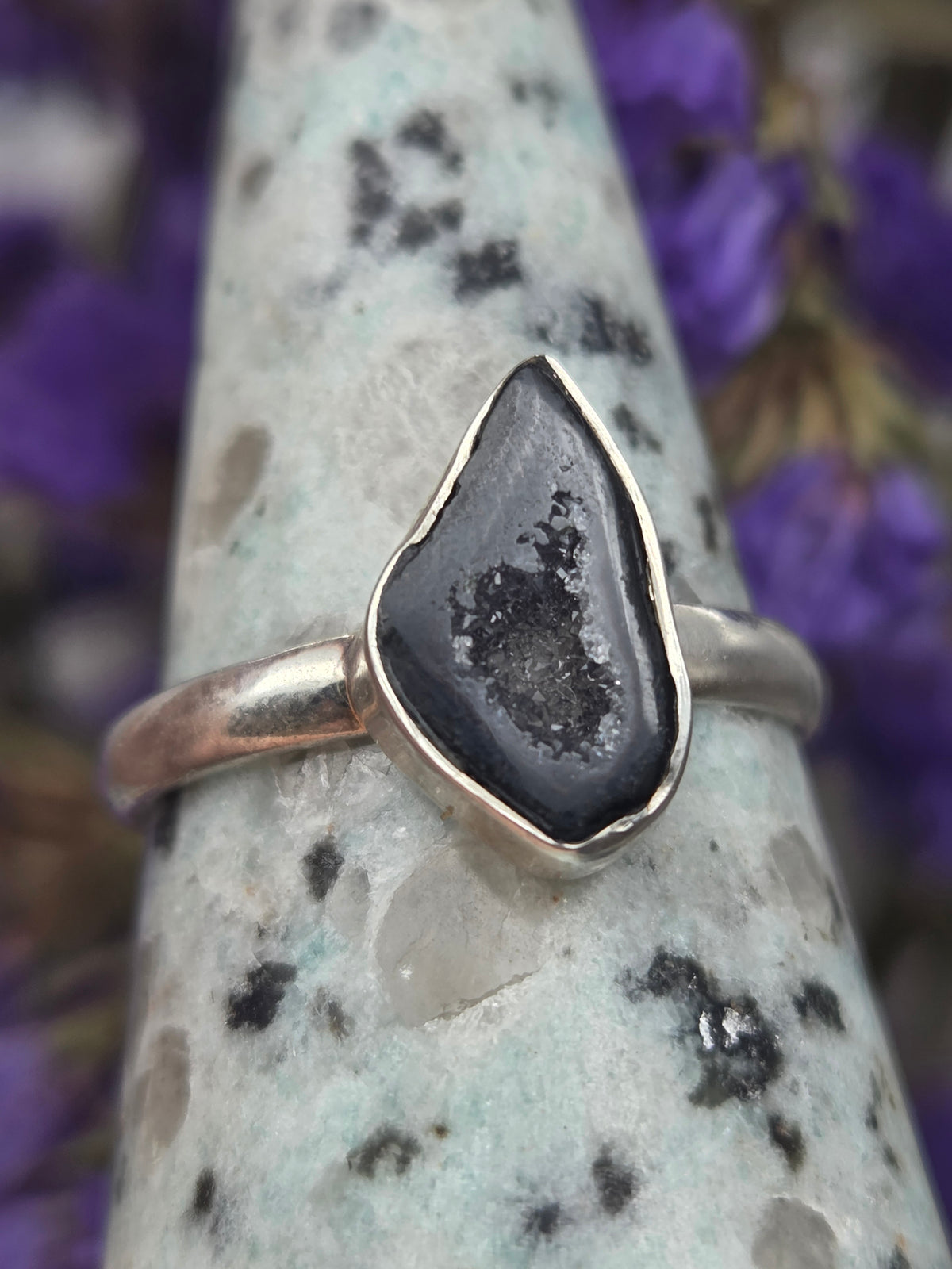 ring with black stone set in silver band