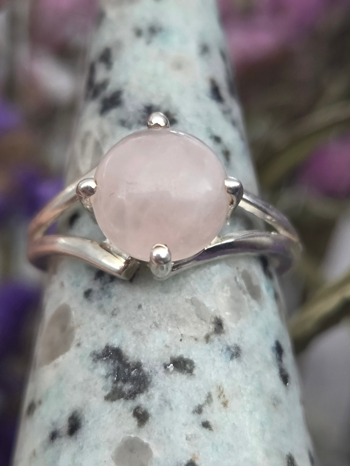 Rose quartz ring with a polished pink stone set in a sleek band