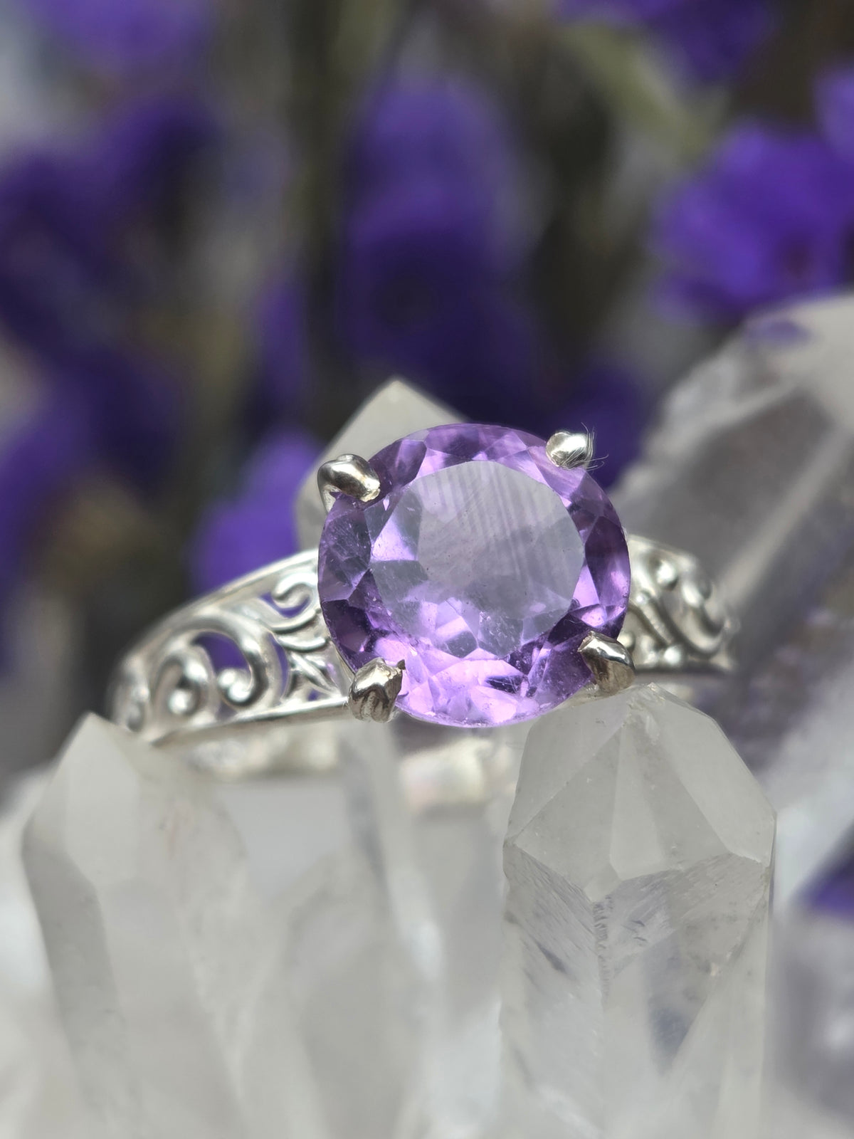 Faceted amethyst ring with intricate band design