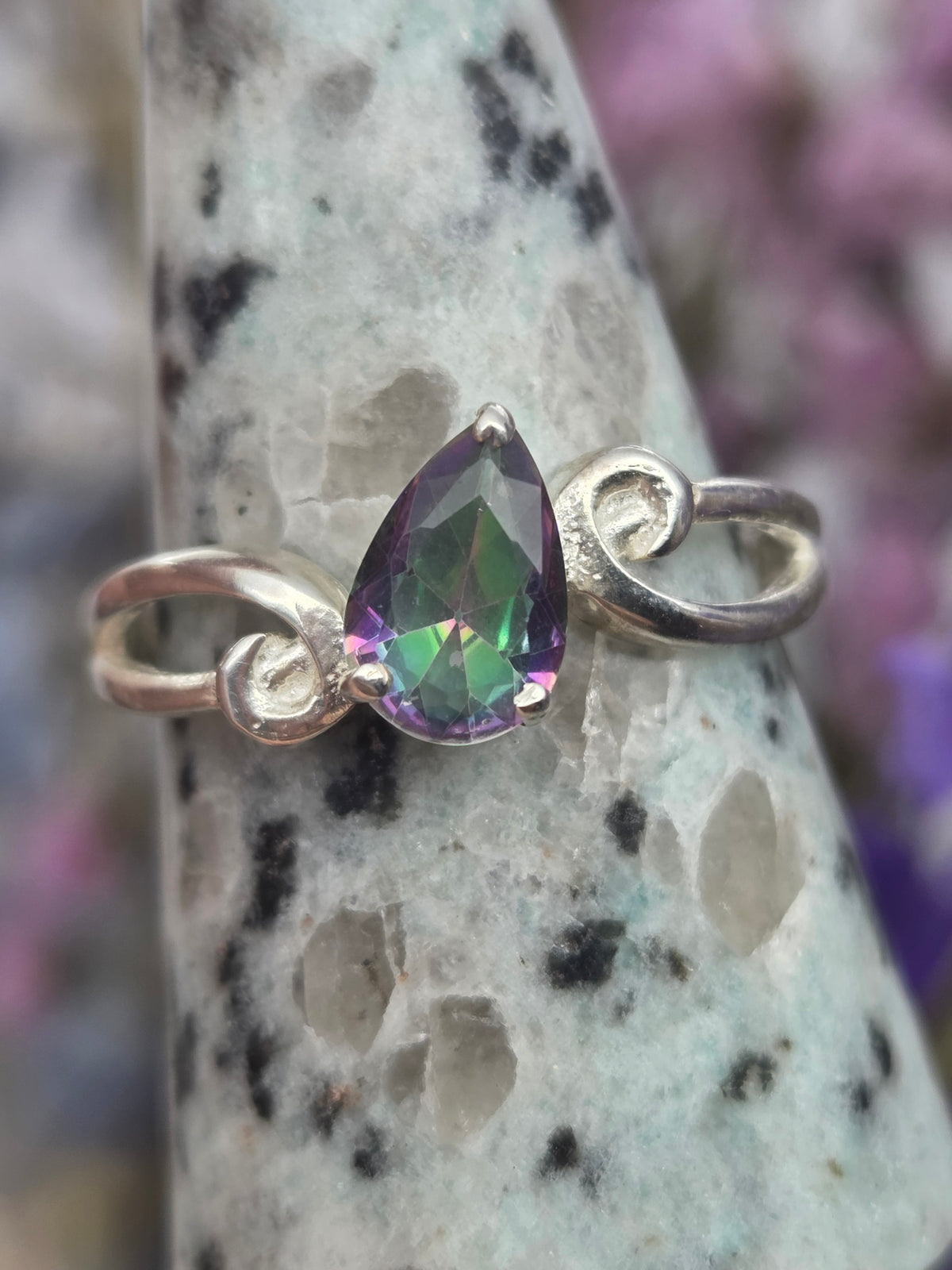 Rainbow silver ring with purple and green hues