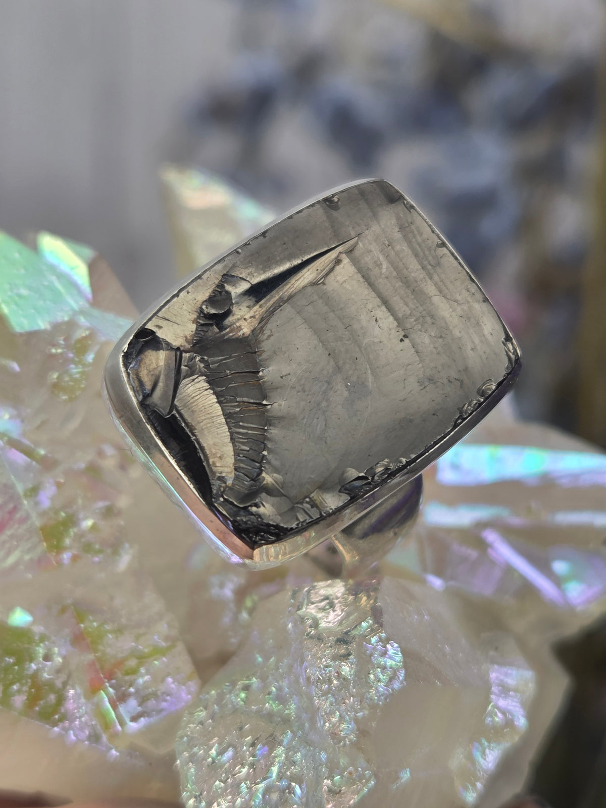 sterling silver ring on iridescent background