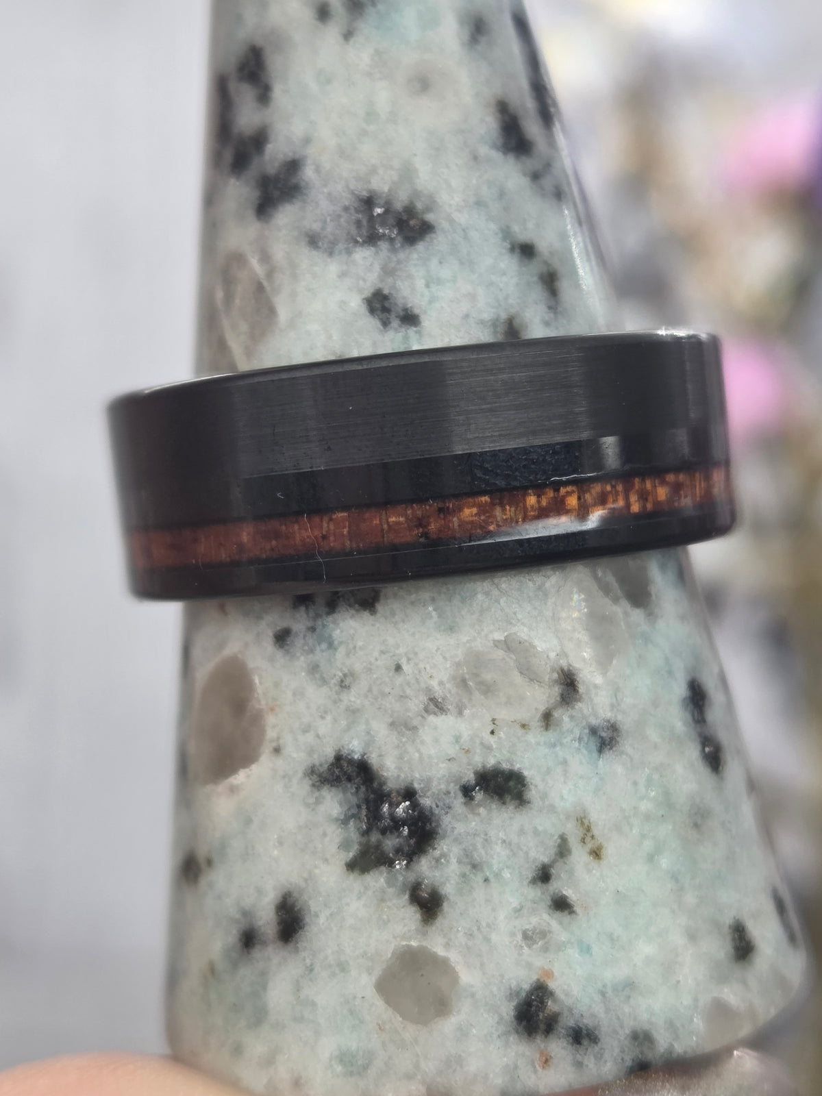 Koa wood and tungsten ring on display