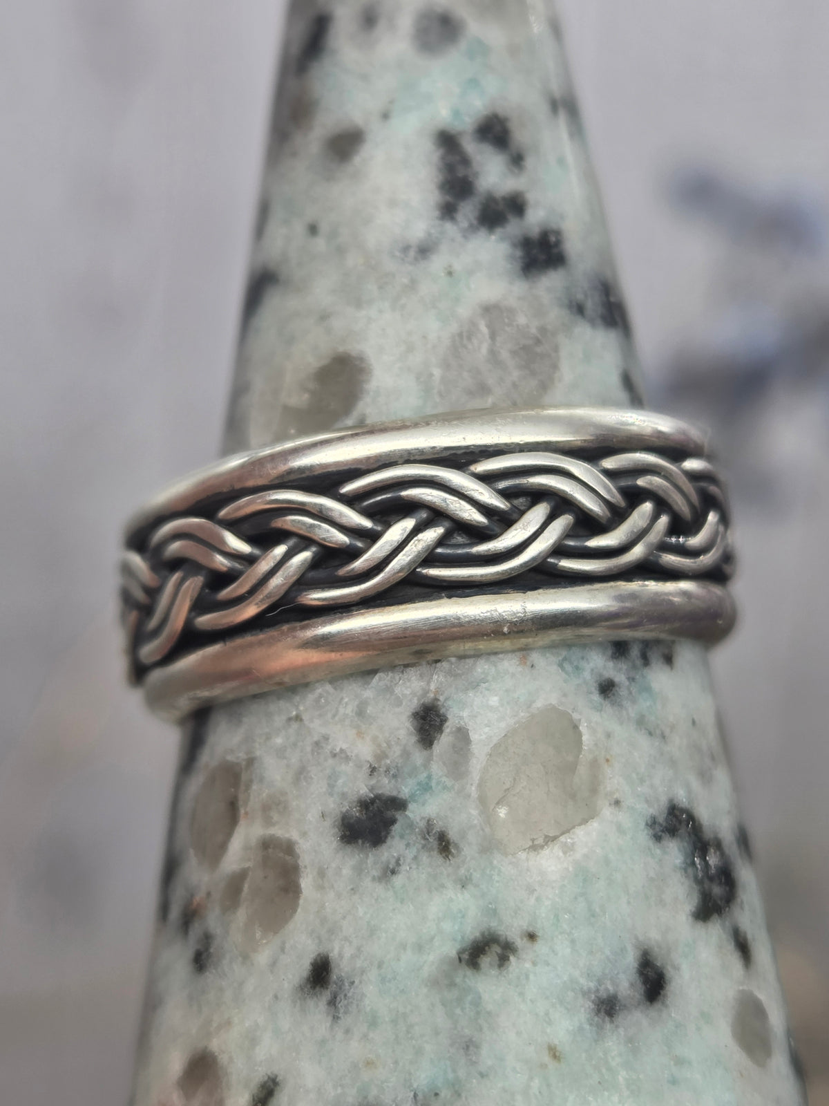 Sterling silver spinner ring with braided design