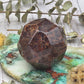 Faceted garnet stone on a decorative background