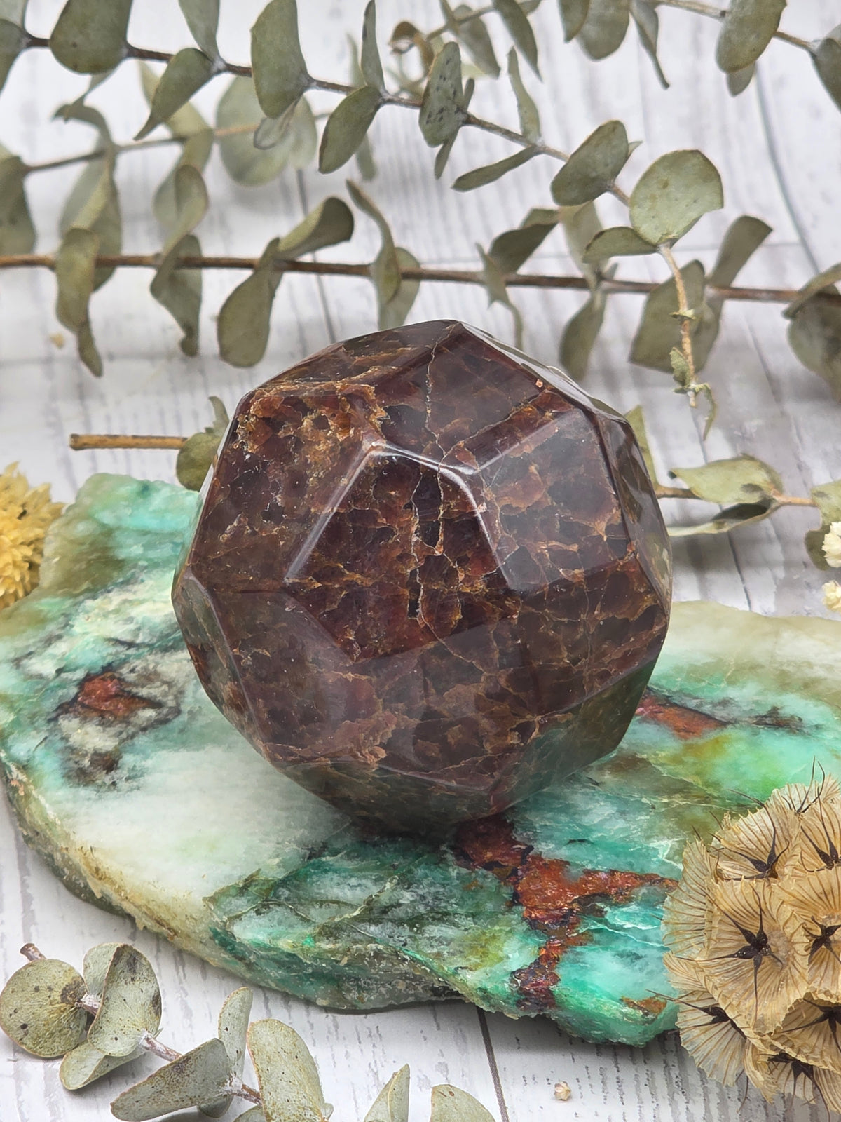 Faceted garnet stone on a decorative background