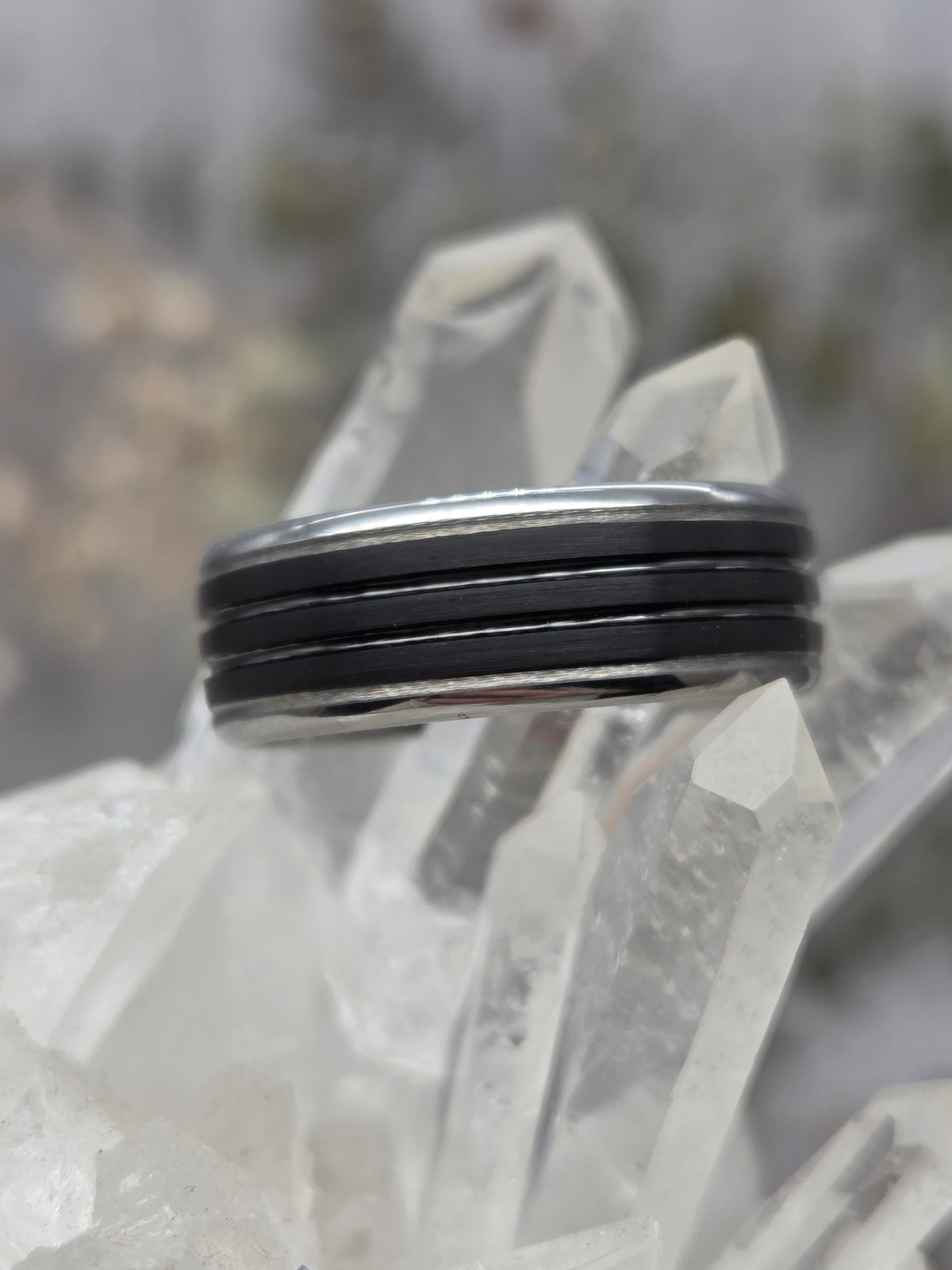 Sterling silver and ring with black accents on a crystal background