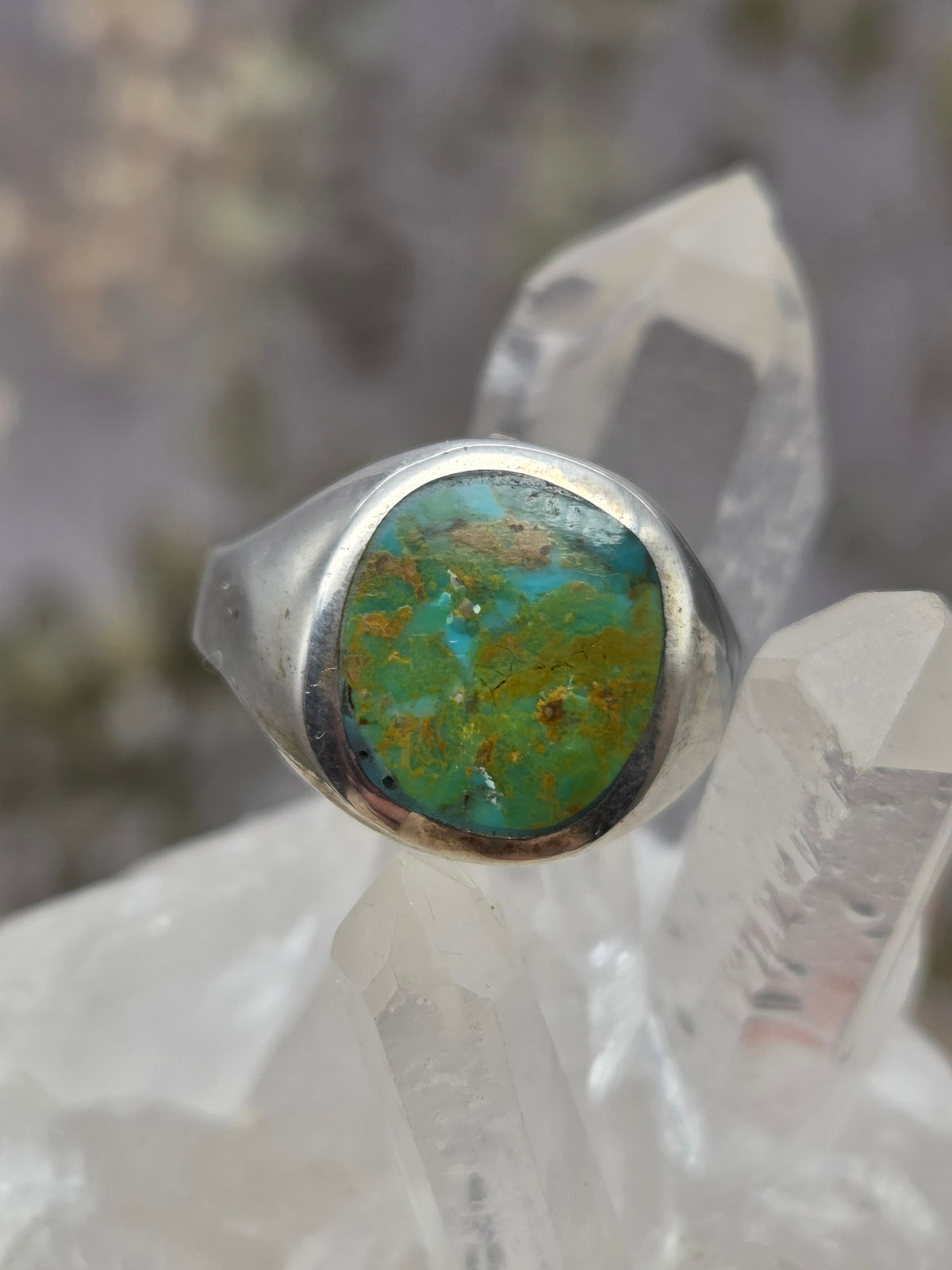 Turquoise sterling silver ring on crystal background