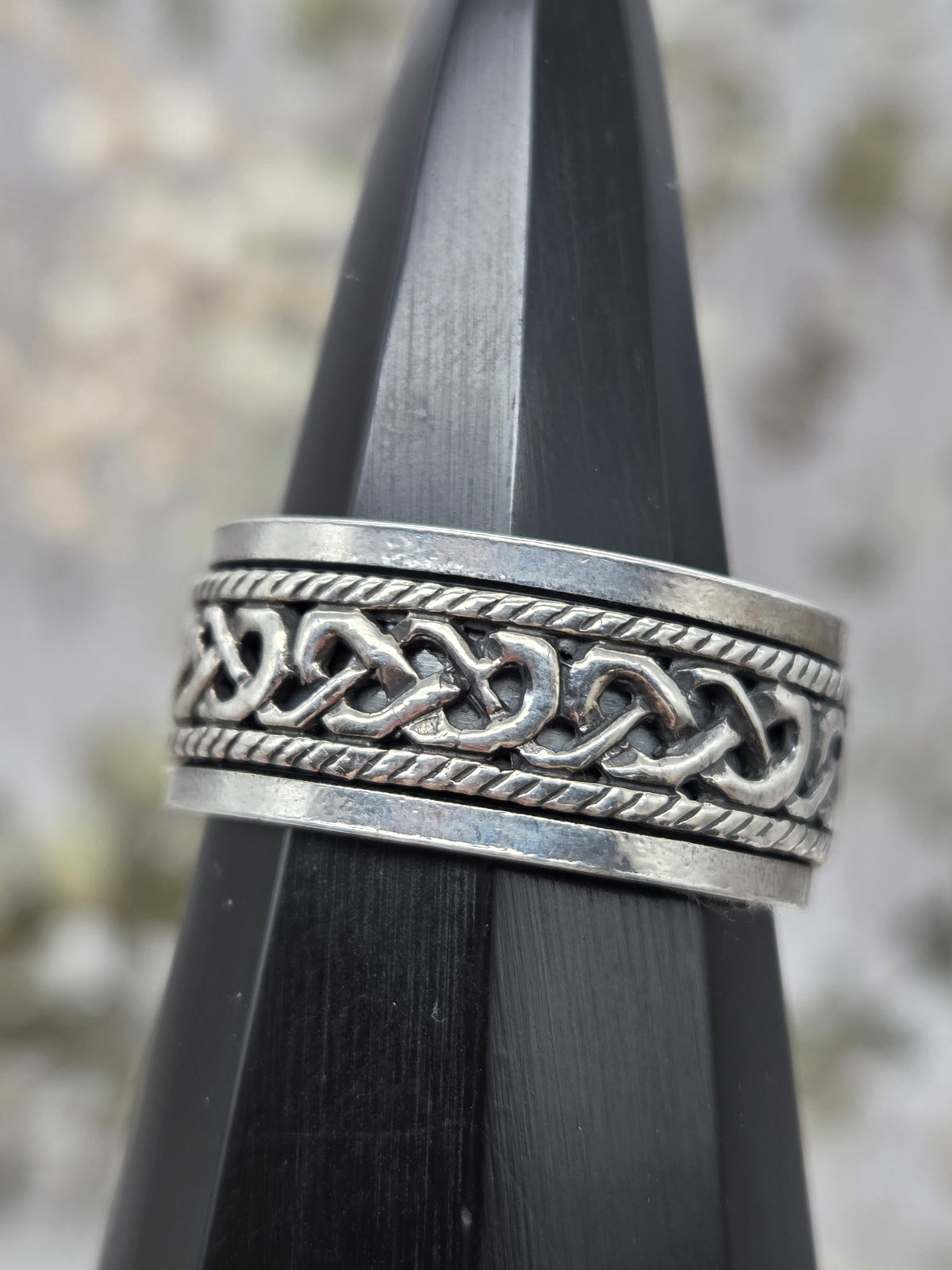 Silver spinner ring with intricate design