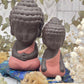 Two Buddha figurines with brown and pink colors