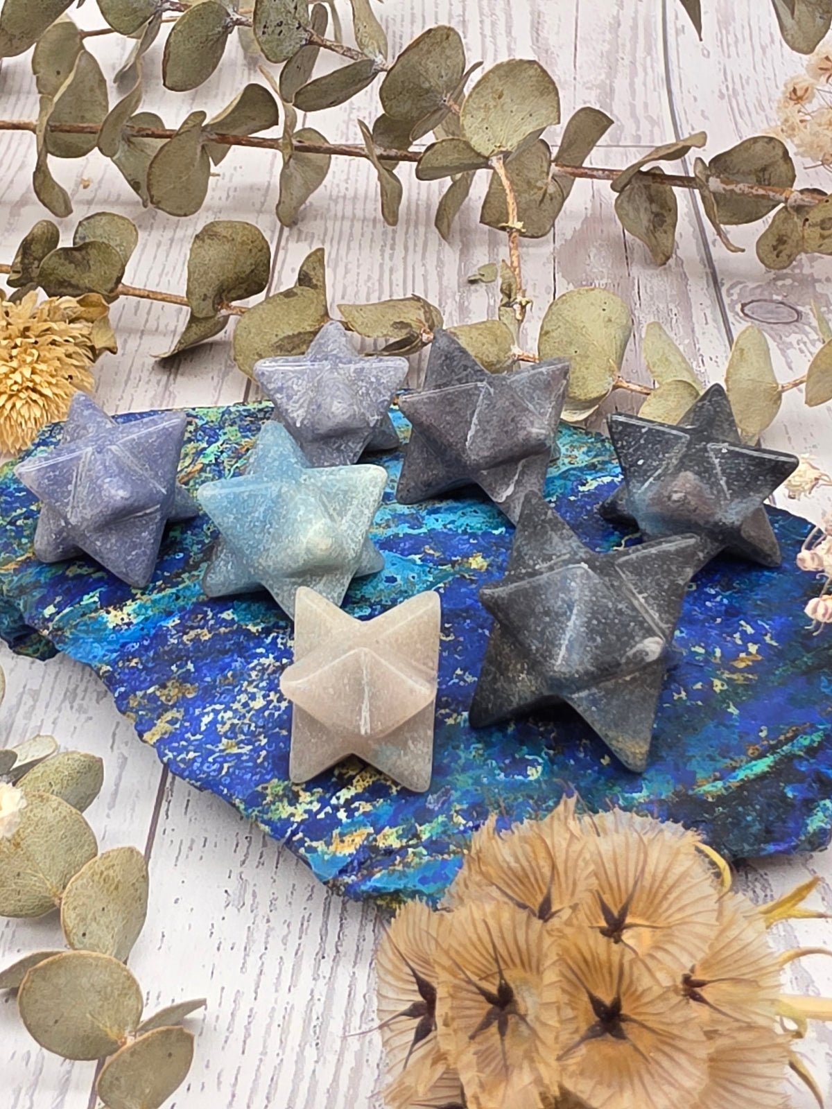 Trolleite Merkaba stars in blue and gray hues on a decorative background