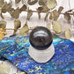 Polished hematite sphere on a stand