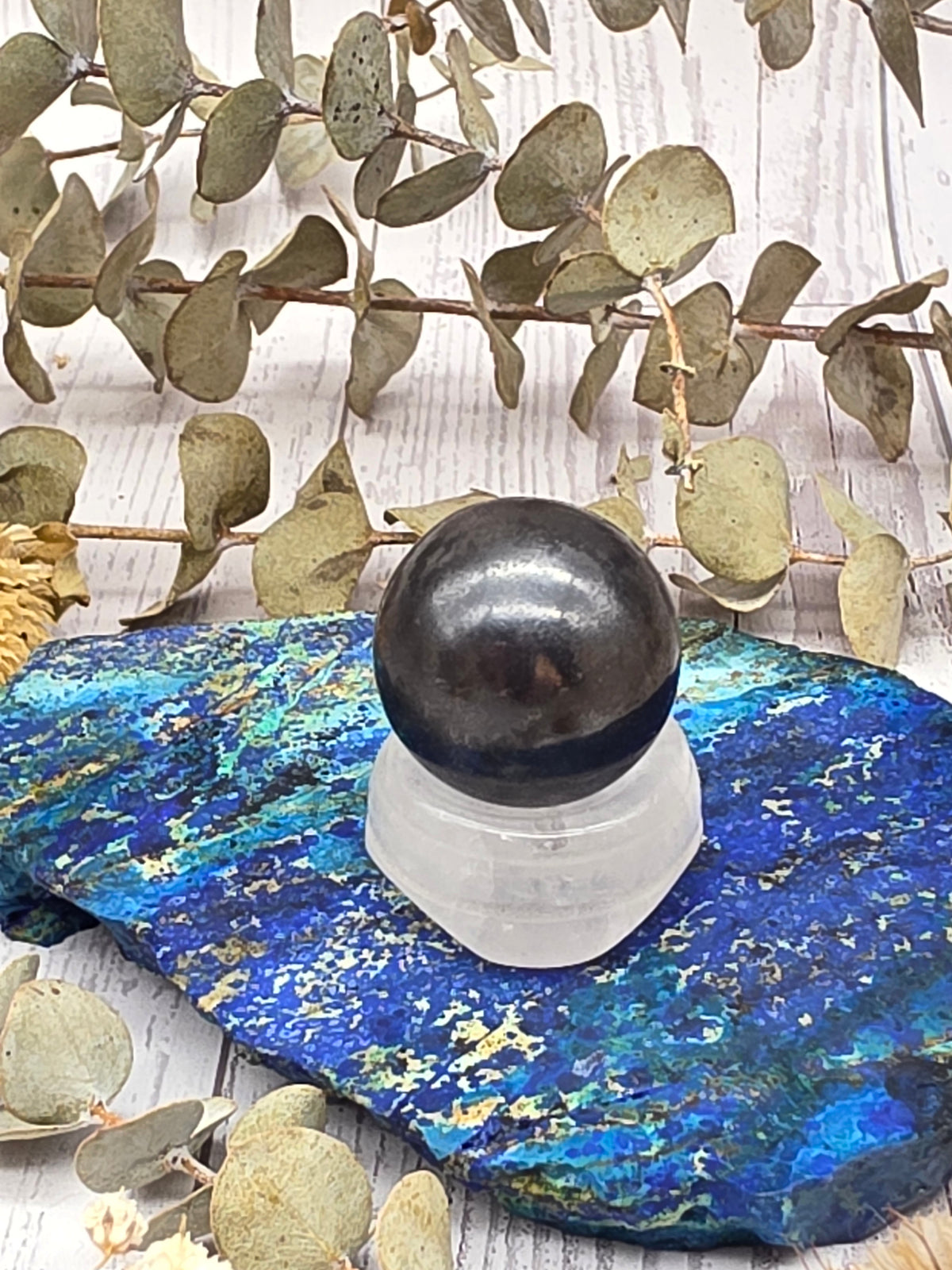 Polished hematite sphere on a stand