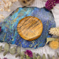 Picture Jasper worry stone on a colorful background with dried flowers