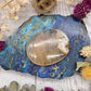 Flower Agate Palm Stone with cream and white patterns on a colorful background