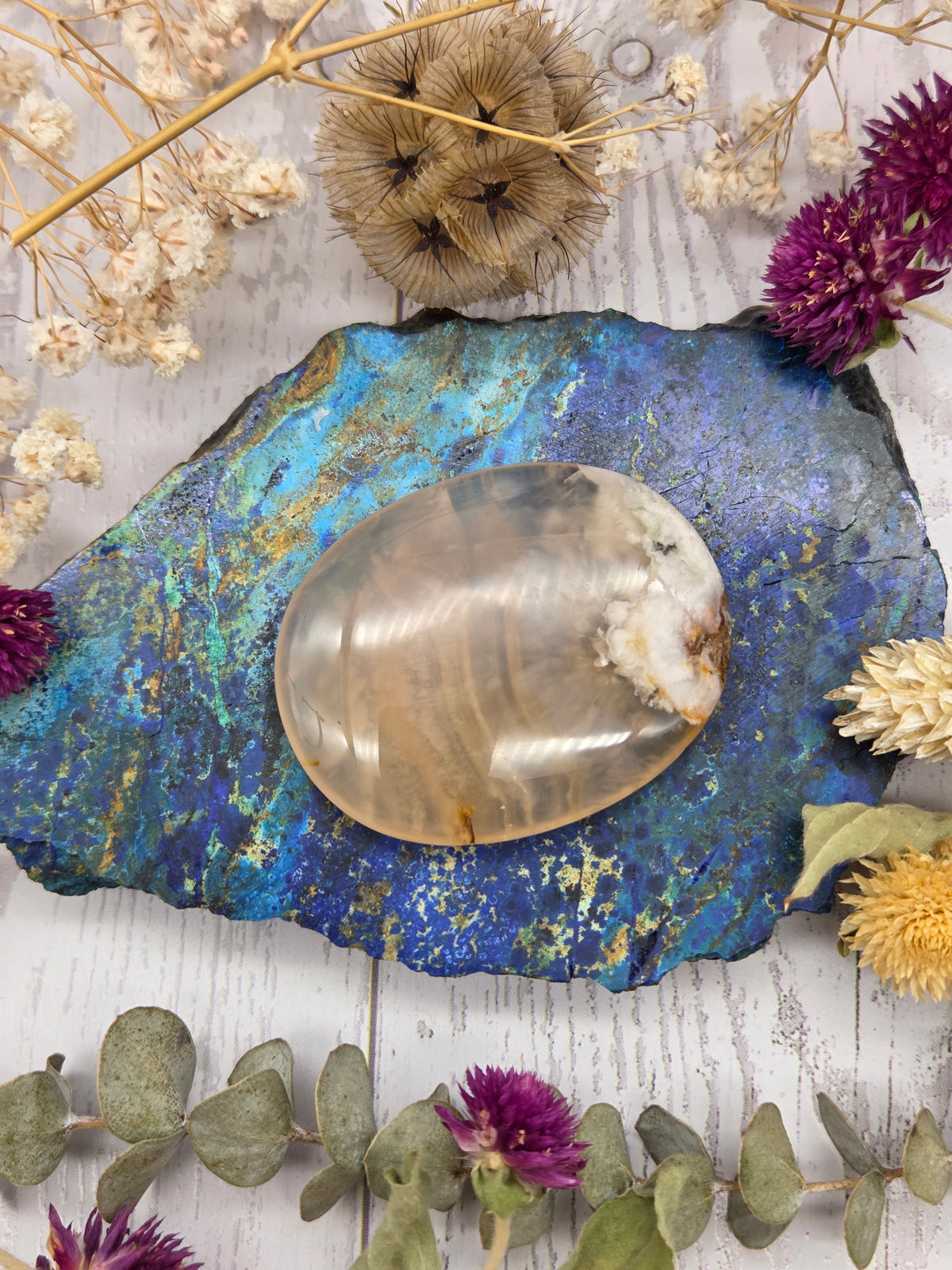 Flower Agate Palm Stone with cream and white patterns on a colorful background
