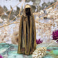 A small brass phantom figurine with a polished surface