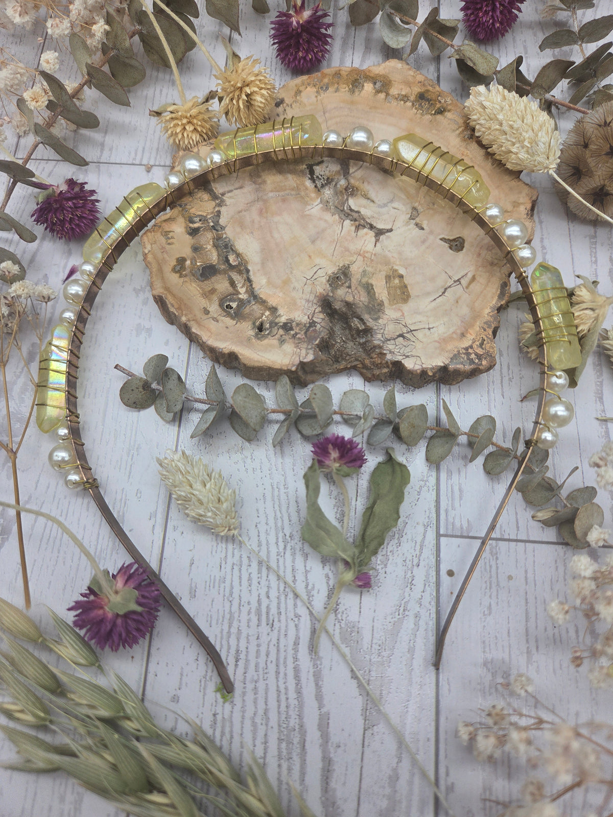 Yellow angel aura quartz and pearl headband on a wooden background