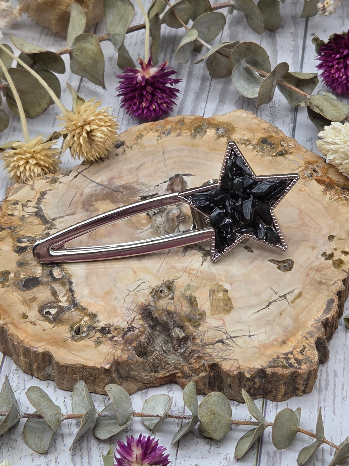 star-shaped crystal barrette on a wooden background
