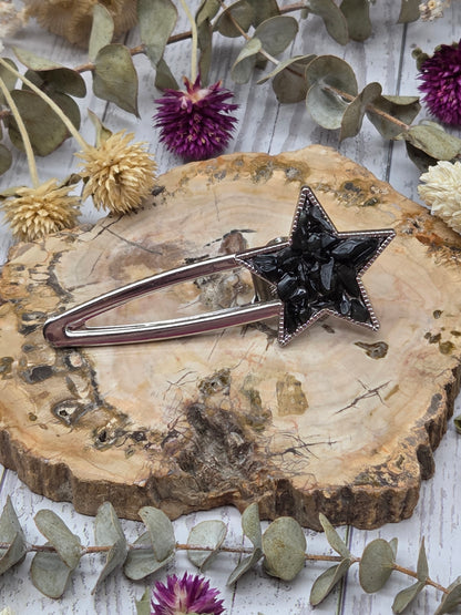 star-shaped crystal barrette on a wooden background