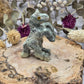 Serpentine rearing horse figurine on a wooden base with floral background