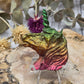 Multicolor Bismuth Unicorn Figurine on a wooden surface