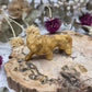 Yellow Aventurine lion carving on a wooden base with dried flowers in the background