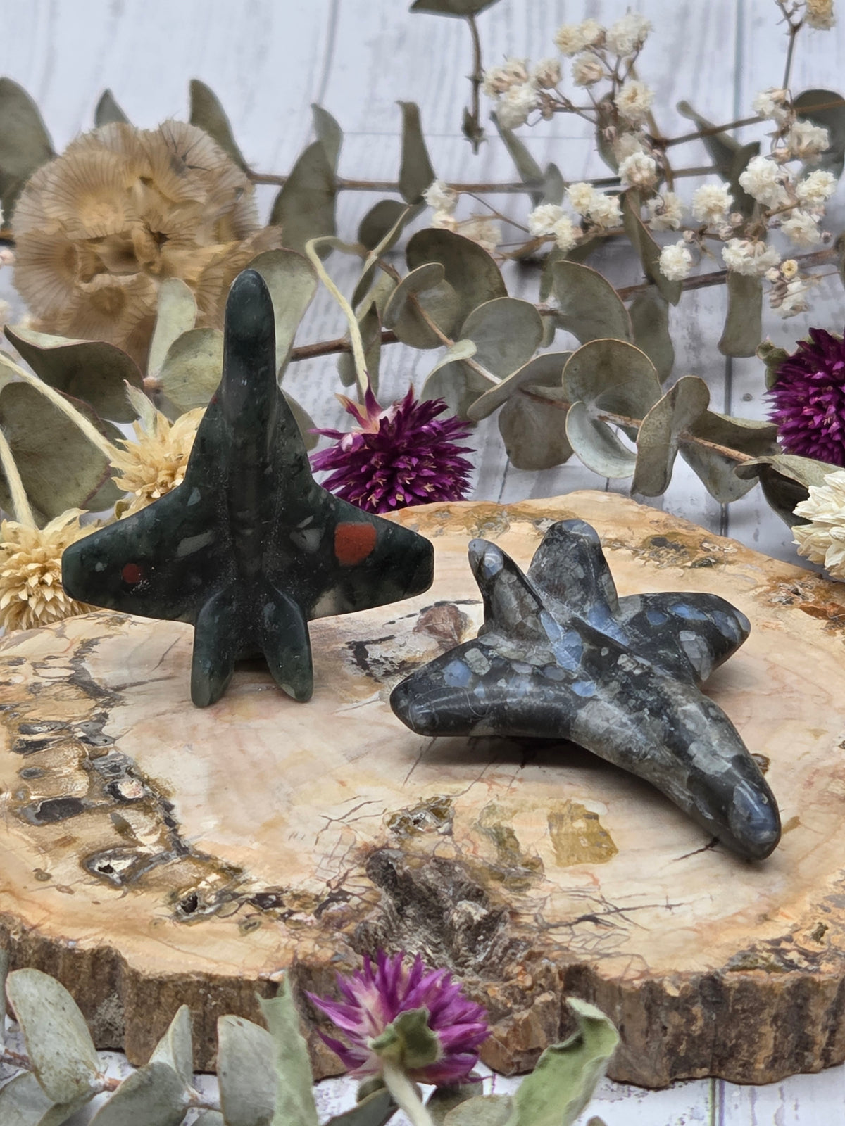 Crystal airplane carving on a wooden base with flowers