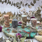 A collection of soapstone snake carvings in various colors