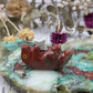 Soapstone otter figurine on a colorful stone background