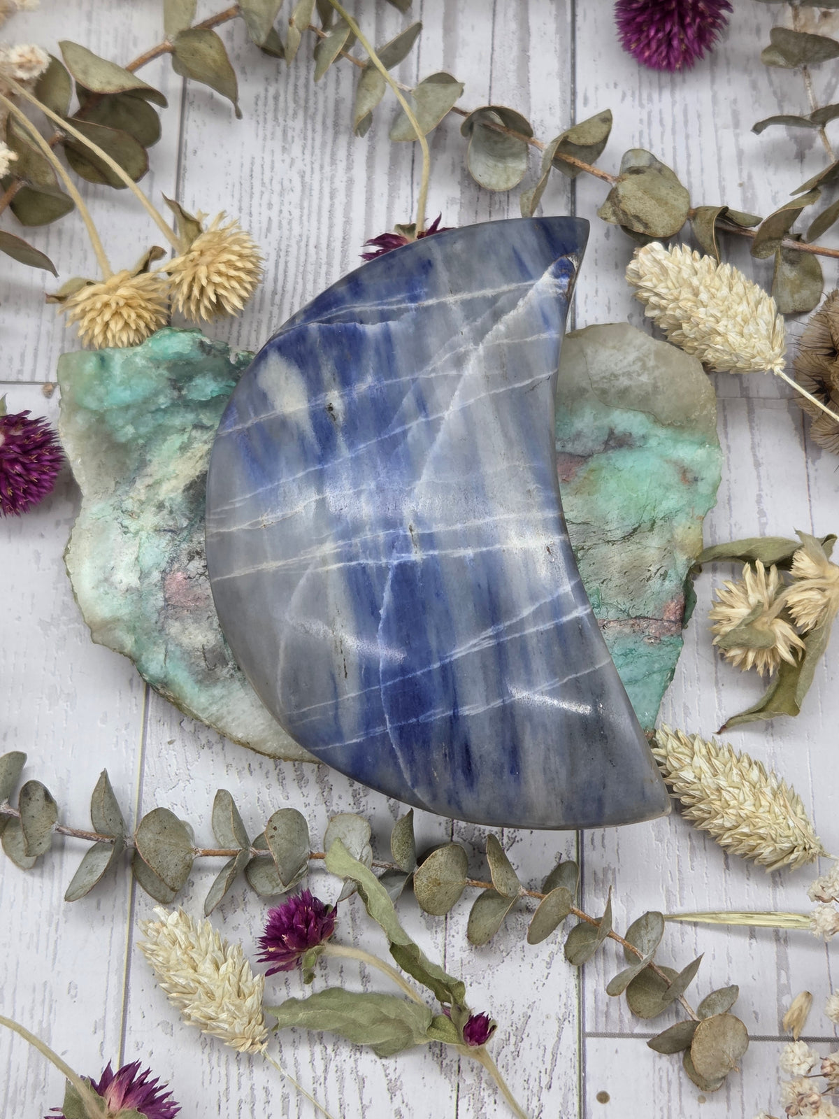 Polished Dumortierite Moon with blue and white patterns
