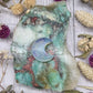 Opalite moon carving on a colorful stone background
