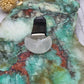 Rainbow Moonstone Car Vent Clip on a colorful stone background
