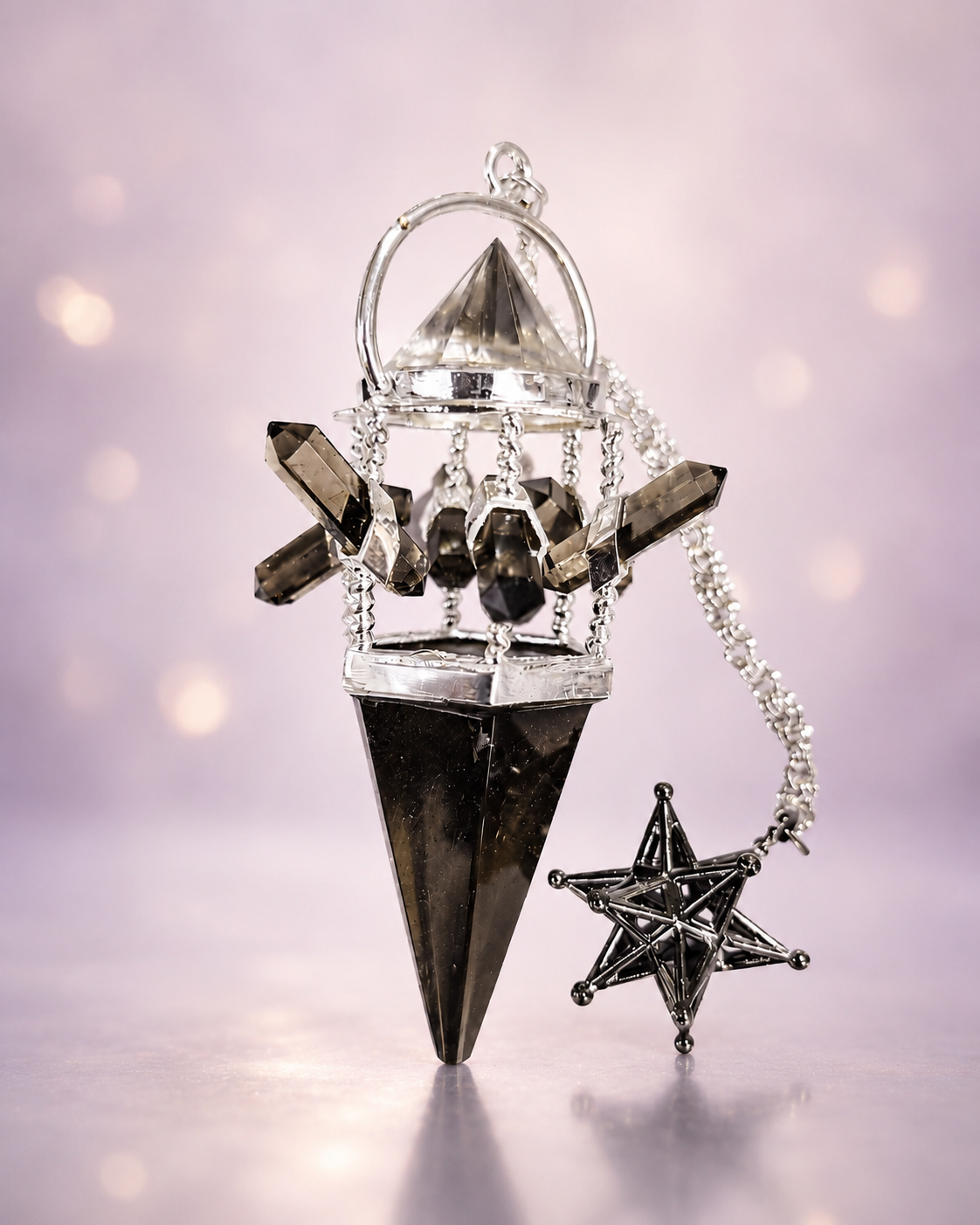 Smoky quartz pendulum with silver chain and star charm on a soft lavender background
