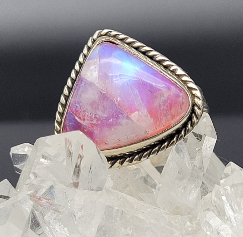 Sterling silver rainbow moonstone ring on quartz crystals